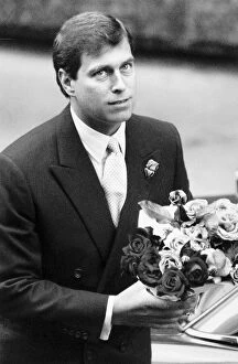 Prince Andrew with bunch of flowers for wife and baby in hospital August 1988