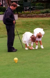 Prince Andrew and daughters Beatrice (R) and Eugenie, August 1998 Placing a golf Prince Andrew and daughters Beatrice (R) and Eugenie, August 1998 Placing a golf
