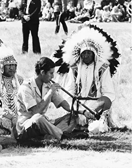 Prince Charles attending a Blackfoot Indian ceremony at Calgary Canada puffs a Prince Charles attending a Blackfoot Indian ceremony at Calgary Canada puffs a