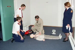 Prince Charles demonstrating resuscitation techniques on an inflatable doll at an Prince Charles demonstrating resuscitation techniques on an inflatable doll at an