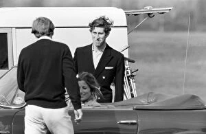 Prince Charles goes for a drive in his Aston Martin with a mystery girl companion at