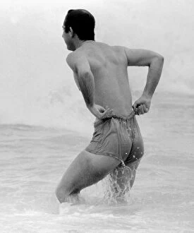 Images Dated 11th March 1979: Prince Charles pulling up his shorts on a beach in Australia royal Prince of