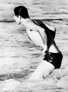 Prince Charles wearing swimming trunks paddling in the sea at Bondi Beach during his Prince Charles wearing swimming trunks paddling in the sea at Bondi Beach during his
