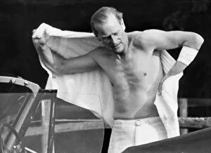 Prince Philip Gallery: Prince Philip shirtless changing for polo. His arm bandaged up after injury. July 1963