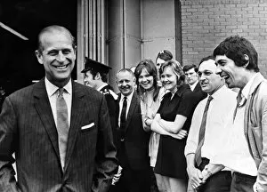 Prince Philip visiting Wales. A smiling Duke of Edinburgh turns after talking to workers