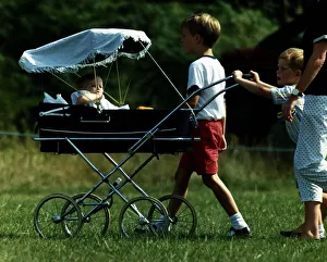 Images Dated 21st July 1989: Prince William Collection 1989 Princess Beatrice is being pushed in pram by