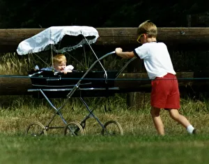 Images Dated 21st July 1989: Prince William Collection 1989 Princess Beatrice in pram being pushed by her cousin