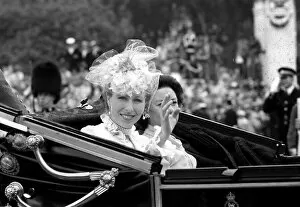 Princess Anne and Princess Margaret waving from a carriage for the wedding of Prince