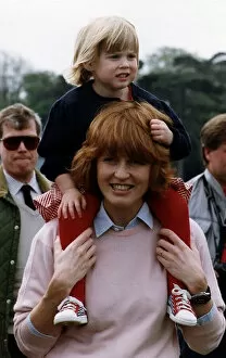 Images Dated 12th May 1991: Princess Beatrice being carried by her mother the Duchess of York