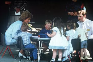 Princess Diana pictured with nursery school children during a visit to the Barnardo'