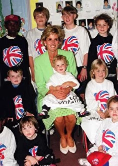 Images Dated 30th June 1996: Princess Diana Princess of Wales with James Perry sitting on her knee during a visit to a