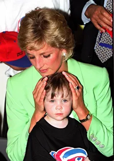 Princess Diana sitting with Caitlin Hines on her lap during a visit to a children' Princess Diana sitting with Caitlin Hines on her lap during a visit to a children'