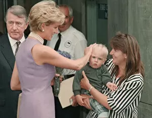 Images Dated 1st November 1996: Princess Diana, wearing a purple dress and necklace greets mother a child during a