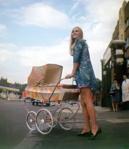 Psychedelic paisley pram with blonde woman wearing psychadelic mini dress Produced Psychedelic paisley pram with blonde woman wearing psychadelic mini dress Produced
