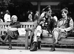 Images Dated 28th April 1987: Two punk rockers sitting on a bench in Birmingham, seated next to them is an elderly lady