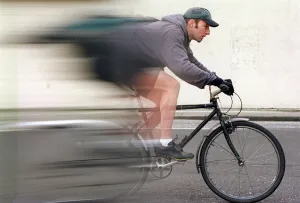 Pushbike courier Brain Dunsmore speeds on bike wearing cap and gloves October 1997 Pushbike courier Brain Dunsmore speeds on bike wearing cap and gloves October 1997