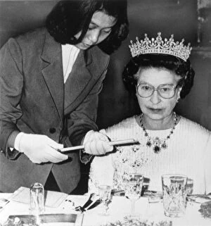 Images Dated 14th October 1986: The Queen in China at a banquet in Peking. Being handed chopsticks to eat sea slugs with