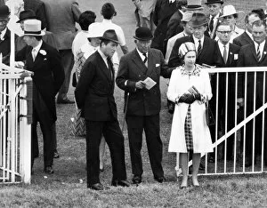 Queen Elizabeth II accompanied by the Duke of Norfolk watching the parade of Oaks runners