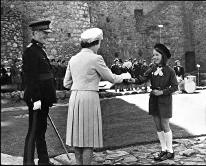 Queen Elizabeth II greets a member of the local brownies, at Harlech Castle, Llandudno Queen Elizabeth II greets a member of the local brownies, at Harlech Castle, Llandudno