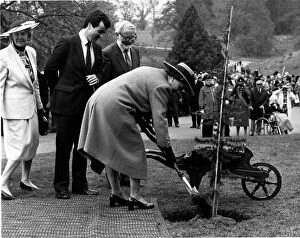Queen Elizabeth II plants a tree before leaving Powis Castle in Wales