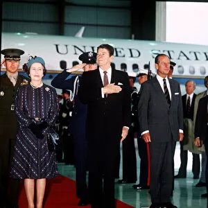 Queen Elizabeth II and US President Ronald Reagan saluting the American National Anthem