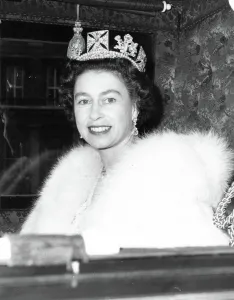 Queen Elizabeth II smiles at cameraman as she left the quadrangle of Buckingham Palce in Queen Elizabeth II smiles at cameraman as she left the quadrangle of Buckingham Palce in