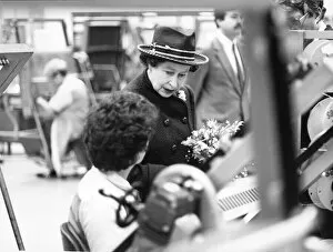 Queen Elizabeth II visits Plessey in Liverpool, and is seen here asking one of the System