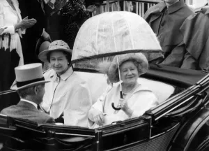 Queen Mother riding down the course with the Queen in an open top carriage in the Ascot Queen Mother riding down the course with the Queen in an open top carriage in the Ascot