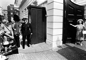 Queen Mother throws open her arms as the gates open at Clarence house as the crowds Queen Mother throws open her arms as the gates open at Clarence house as the crowds
