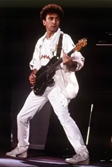 Images Dated 10th July 1986: Queen Rock Group John Deacon playing bass guitar Queen in concert at Wembley