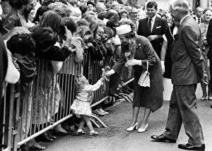 One of the Queen's tinier subjects hands over a posy in Welshpool. 12th July 1986