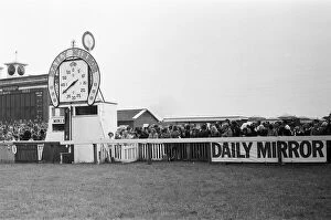 Racegoers gather at the finishing post during the Andy Capp Handicapp race meeting at