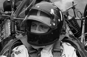 Racing driver Graham Hill at Brands hatch circuit 1970 sitting in Lotus car in