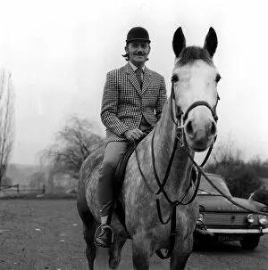 Racing driver Graham Hill on horse at home 1970