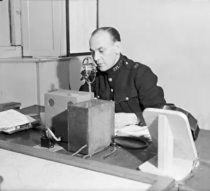 Radio and telegraph officer on duty in Scotland Yard's information room Radio and telegraph officer on duty in Scotland Yard's information room