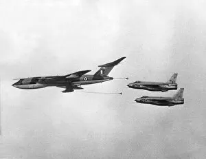 Two RAF English Electric Lightning jet fighter aircraft prepare to refuel from a Handley