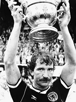 Images Dated 25th May 1985: Rangers and Scotland football player Graeme Souness with the Sir Stanley Rous Trophy