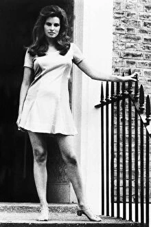 Images Dated 9th December 1977: Raquel Welch standing by door in small dress holding onto the side December