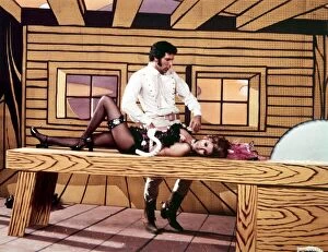 Images Dated 12th January 1970: Raquel Welch and Tom Jones acting during a TV show television lying on a