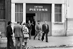 Images Dated 21st April 1975: Renault factory workers leaving at the end of a shift through a door marked '