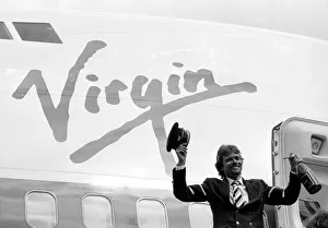 Images Dated 21st June 1984: Richard Branson drinking from a bottle of champagne as he celebrates Virgin Atlantic