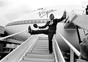 Images Dated 21st June 1984: Richard Branson drinking from a bottle of champagne as he celebrates Virgin Atlantic