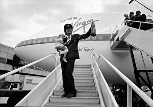 Images Dated 21st June 1984: Richard Branson holding a bottle of champagne and his daughter on the steps of