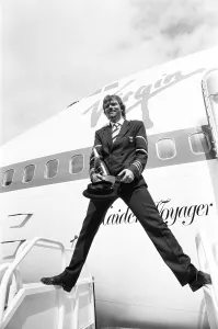 Images Dated 21st June 1984: Richard Branson seen here dressed as a Virgin Atlantic pilots with a bottle of champagne