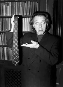 Rik Mayall holding up a tie Making a funny face January 1989 Rik Mayall holding up a tie Making a funny face January 1989