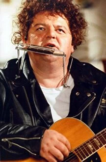 Robbie Coltrane actor playing harmonica and guitar