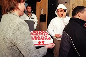 Images Dated 12th February 1999: Robbie Williams gets a 25th birthday cake from Margaret Mallon February 1999 as he walks