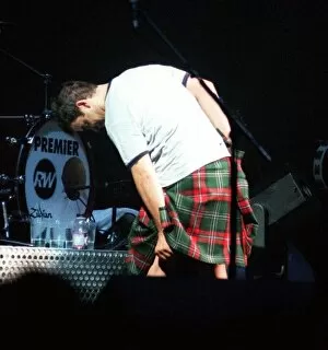 Robbie Williams wearing kilt starting to pull it up February 1999 during SECC concert