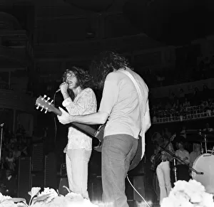Robert Plant ,lead singer of rock group Led Zeppelin, performing on stage during a Robert Plant ,lead singer of rock group Led Zeppelin, performing on stage during a