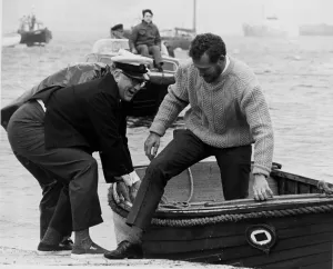 00093 Gallery: Robin Knox Johnston is helped on to dry land after winning the 1968-69 Sunday Times